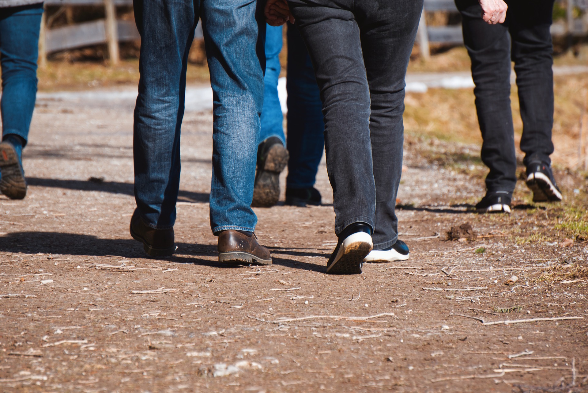 Picture of people walking showing only the lower legs and feet.